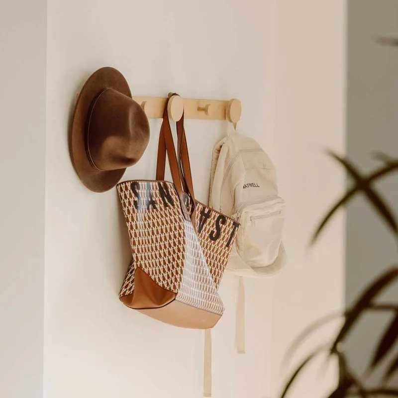 Wall coat rack with pegs